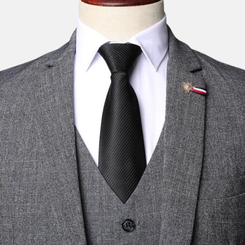 Close-up of grey herringbone tweed suit with notch lapel and V-neck vest