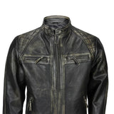 Close-up of men’s distressed black leather biker jacket with snap collar and antique gold zippers