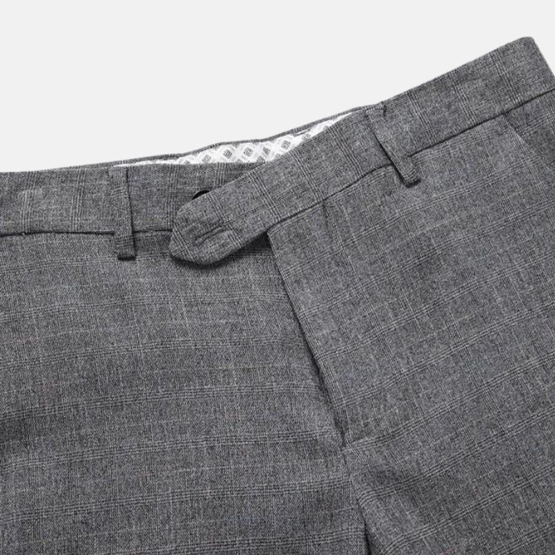 Close-up of men’s grey herringbone suit trousers with waistband and side pocket