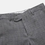 Close-up of men’s grey herringbone suit trousers with waistband and side pocket