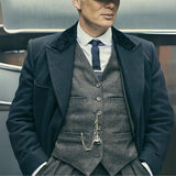 Grey tweed vest and trousers styled with a dark overcoat for a 1920s-inspired look